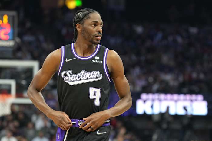 Justin Holiday tucks in his black Sacramento Kings jersey.